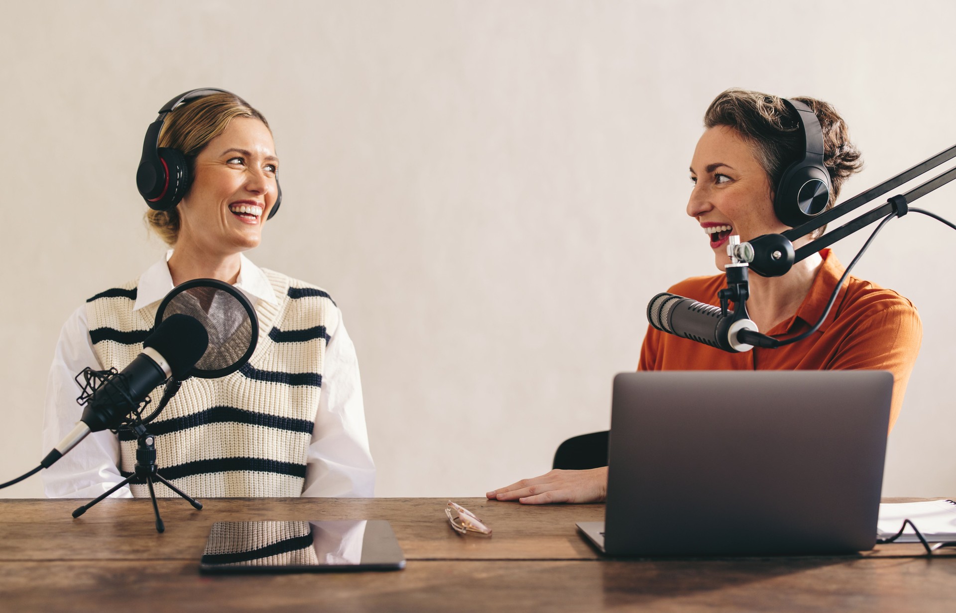 Happy podcasters having a good time in a home studio